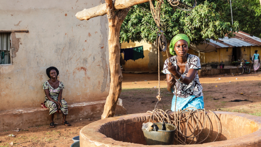 African woman pulling water out of a well
